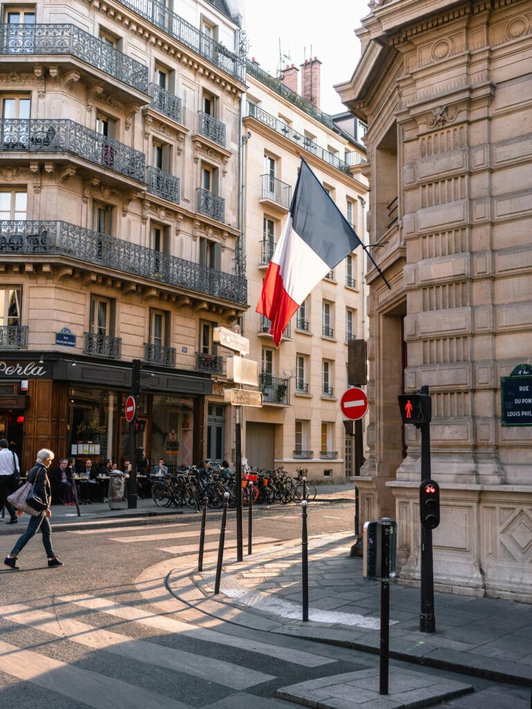 Charming French street adorned with the French flag waving proudly.