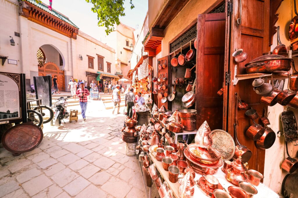 Labyrinthine streets of the Fez Medina, lined with colorful shops and traditional Moroccan architecture.