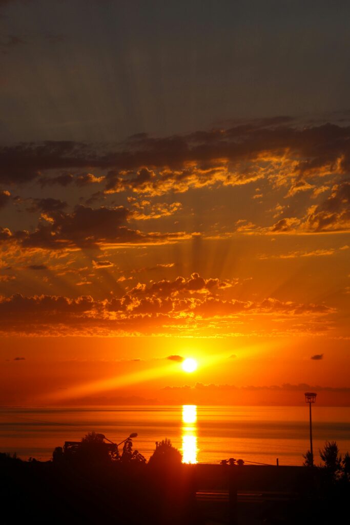 A peaceful beach at sunset, with golden waves and a tranquil atmosphere, perfect for mindful travel.