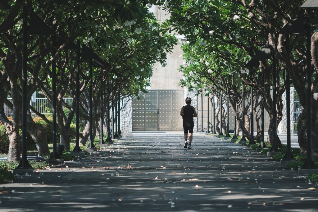 A determined man running on an open road, symbolizing self-discipline and perseverance.