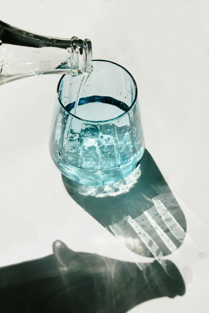 A close-up of a refreshing glass of water being poured, highlighting purity and hydration.