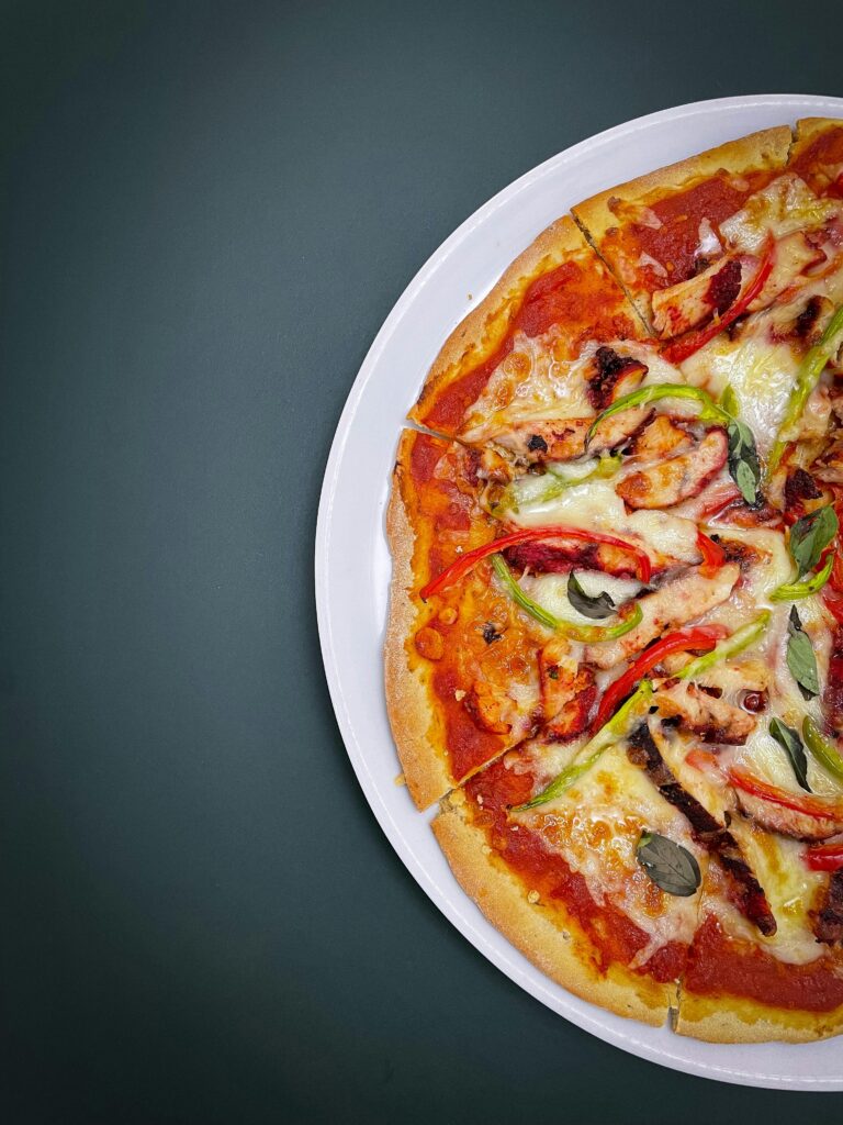 Close-up of a freshly baked Margherita pizza with a crispy golden crust, vibrant tomato sauce, melted mozzarella cheese, and fresh basil leaves.