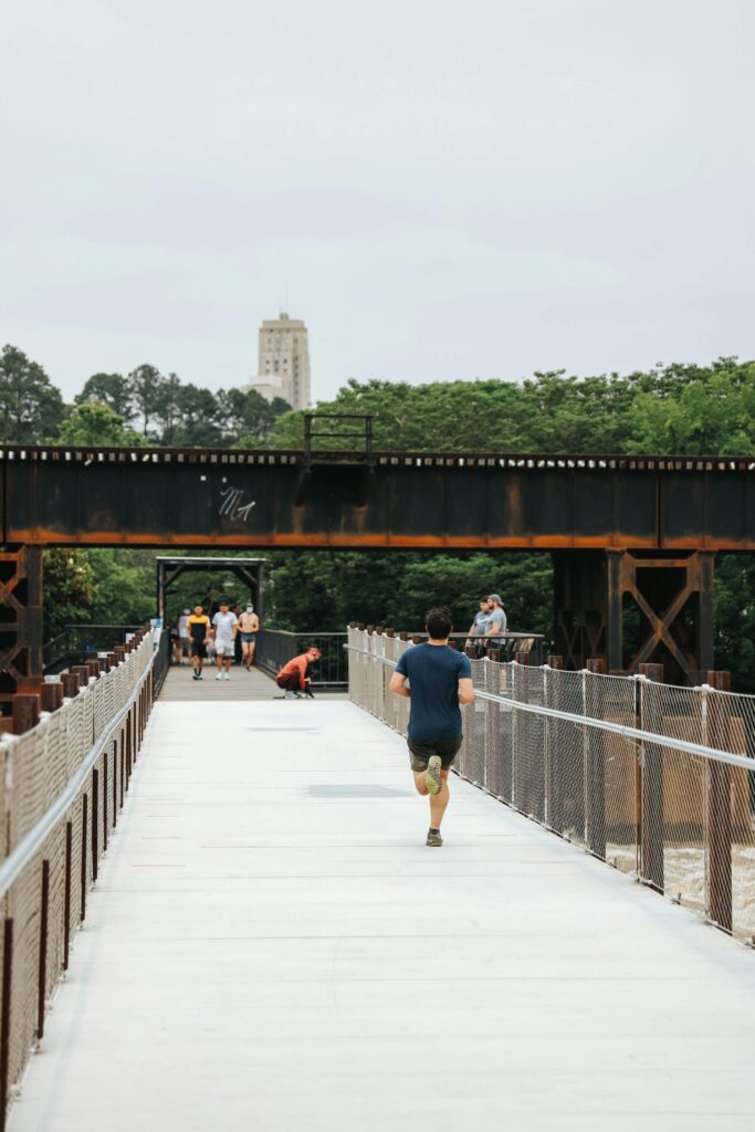 A runner jogging on a scenic trail during sunrise, symbolizing resilience, mental strength, and the transformative power of running.